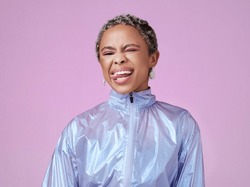 Retro fashion, black woman and tongue out portrait, funny face or flirting in unique makeup, colorful neon and pink studio background. Crazy, bold and happy gen z influencer model in techno vaporwave