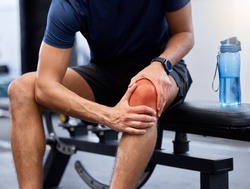 Exercise, man and knee pain in gym, bench and injury after practice, workout and fitness. Healthy male, athlete and training for wellness, healthcare and muscle tension with intense joint strain.