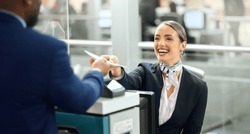 Airport, passport and travel with a woman passenger assistant helping a business man traveller with check in. Security, immigration or documents with a female working in a terminal for border control