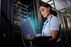 Laptop, network and data center with a black woman it support engineer working in a dark server room. Computer, cybersecurity and analytics with a female programmer problem solving or troubleshooting