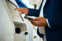 Hand, phone and atm with a business black man at the bank to withdraw cash from a convenient machine. Money, finance and smartphone with a male employee making a financial transaction on credit