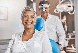 Portrait, happy and dental with a woman patient in a doctor office for oral hygiene or health. Smile, teeth and healthcare with a senior female sitting in a chair at the dentist for hygiene