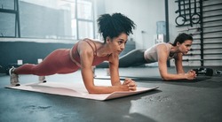 Girl friends, plank and gym fitness of women doing exercise, workout and body wellness. Motivation, woman focus and challenge of people in sports training and athlete class exercising for health
