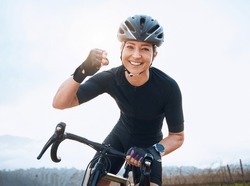 Fitness, celebration and portrait of woman cycling with power fist, success or victory in the countryside. Happy, sports and face of lady cyclist celebrating workout achievement, milestone or winning