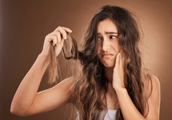 Hair loss, crisis and worried woman in studio for beauty, messy and damage against brown background. Haircare, fail and sad girl frustrated with weak, split ends or alopecia, dandruff and isolated