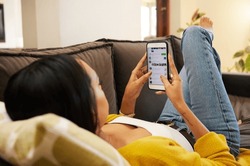 Phone, hands and woman on social media on sofa in home living room, typing or texting. Cellphone, relax and person or female web scrolling, online browsing or networking, reading and messaging alone