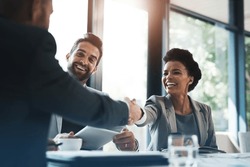 Happy business people, handshake and meeting in teamwork for partnership or collaboration in boardroom. Woman person shaking hands in team recruiting, introduction or b2b agreement at the workplace