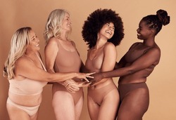 Support, love and diversity of women in underwear, beauty collaboration and smile for body positivity against brown studio background. Community, care and model people with solidarity and confidence