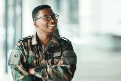 Soldier with smile, confidence and arms crossed at army building, pride and happy professional in sevice. Military career, security and courage, black man in camouflage uniform at government agency.