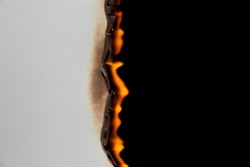 Burning paper on black background. Burnt paper edges.