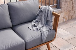 throw blanket,wood sofa and in the yard and garden on the garden tiles

