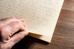 the page of a book written in the Braille alphabet, the tactile reading system in relief for the blind