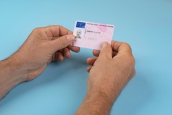 a man with an Italian driving license in the hands