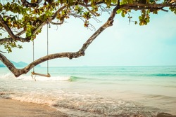 Wooden swing on  tropical beach 