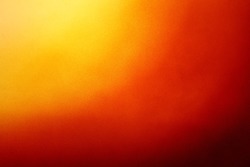 Abstract colorful background with grunge noise grain texture and vivid radial color gradient of red, orange, brown and yellow from corner