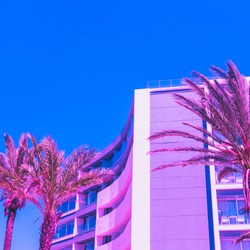 pink palm trees  and hotel against the blue sky. bright neon colors. minimal and surreal. summer holidays. urban style. 80s style