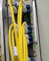 Fiber Optical data cables connected to an optic ports and Network cables connected to ethernet port and UTP Network cables 