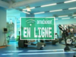 in French sign online workout, due to the closure of the hall during the lockdown. empty Modern gym interior with equipment