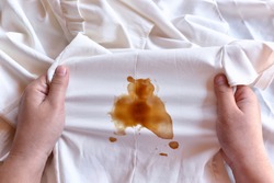 Dirty sauce stain on fabric from accident in daily life. Concept of cleaning stains on clothes or cleaning the house. Selected focus