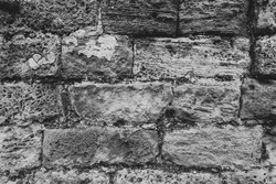 Part of a Brick Wall. Background or Texture. Surface of ancient obsolete Brickwall Outside the Street. Close Up Texture. BW Photo