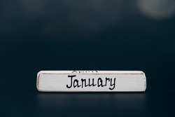 January Image of January wooden color calendar dark background. empty space for text.