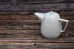 White tea pot ceramic wooden table, Vintage tone. Top view.
