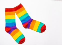 a pair of rainbow colorful socks at white background