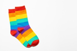 a pair of rainbow colorful socks at white background