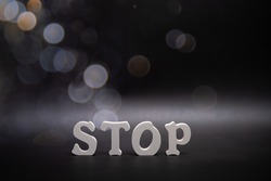 Word Stop on dark backround with bokeh Copy space. Banner.