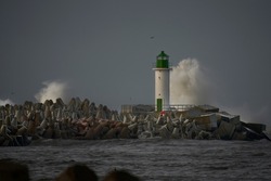 Waves crashing over a lighthouse