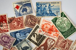 Old Australian Stamps - 1960s:[A small selection of old, used, and circulated Australian stamps. Subjects captured against soft window lighting on white bond paper background.]