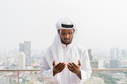 Portrait of young African Muslim man wearing religious clothing an scarf