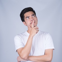 Portrait handsome young asian man wearing a white T-shirt thinking and stress isolated on whitel  background.Asia man people. business concept.Copy space.