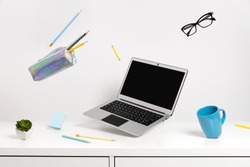 Office supplies stationery levitate over white table. Back to school work education creative layout