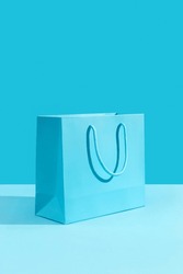 Paper shopping bag on blue background. Shopping sale delivery concept