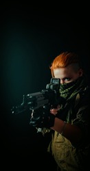 Young woman with red hair and girl with a bandage on his face, hold machinegun in military uniform. Vertical background