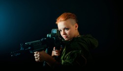 Young woman with red hair, hold machinegun in military uniform. horizontal background