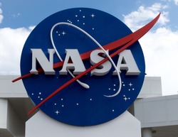 NASA sign at Cape Canaveral, Kennedy Space Center with blue cloudy sky background. Elements of this image furnished by NASA.