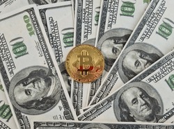 Golden bitcoin banknotes on electronic banknote. Luxury bitcoins in form of a golden dollar. Mining and trading virtual currencies. 100 US dollar bills and golden bitcoins with a smartphone 