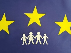 European Union flag with family figurines. Obtaining residence permit In Europe and refugees. European families and insurance