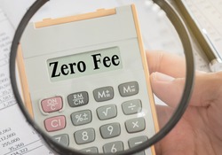 zero fee text displayed on calculator and magnifier. bank fees, service fee concept.