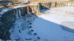 Snow covers this empty rock quarry with no human activity this season.