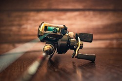 fishing casting reel on a rod with a cord