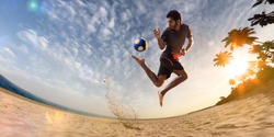 Beach soccer player in action. Sunny beach wide angle