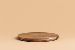 Round wooden podium for food products or cosmetics on a bright brown background.
