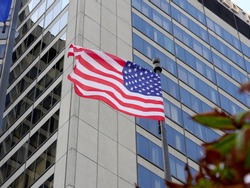 American flag on the background of a modern building.