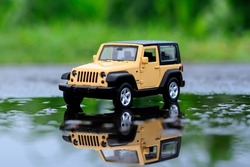 Yellow car toys on the rood photo with nature background
