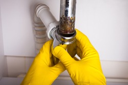 Washbasin's siphon cleaning in a bathroom