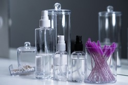 Cosmetic empty bottles and containers. Organizers for cotton swabs and disks. Beauty saloon.