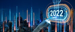 
concept of new year 2022 Vision Technology and Modern city with wireless network connection.Robot finger,Big data and business concept.Robot finger on word 2022 and city network connection background